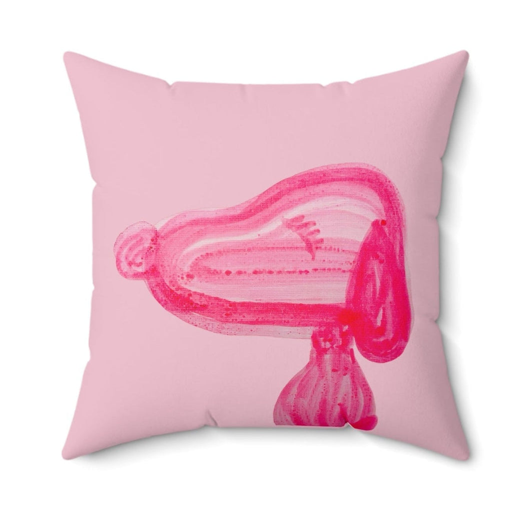 Pink pillow with a stylized pink design on a white background