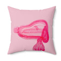 Pink pillow with a stylized pink design on a white background