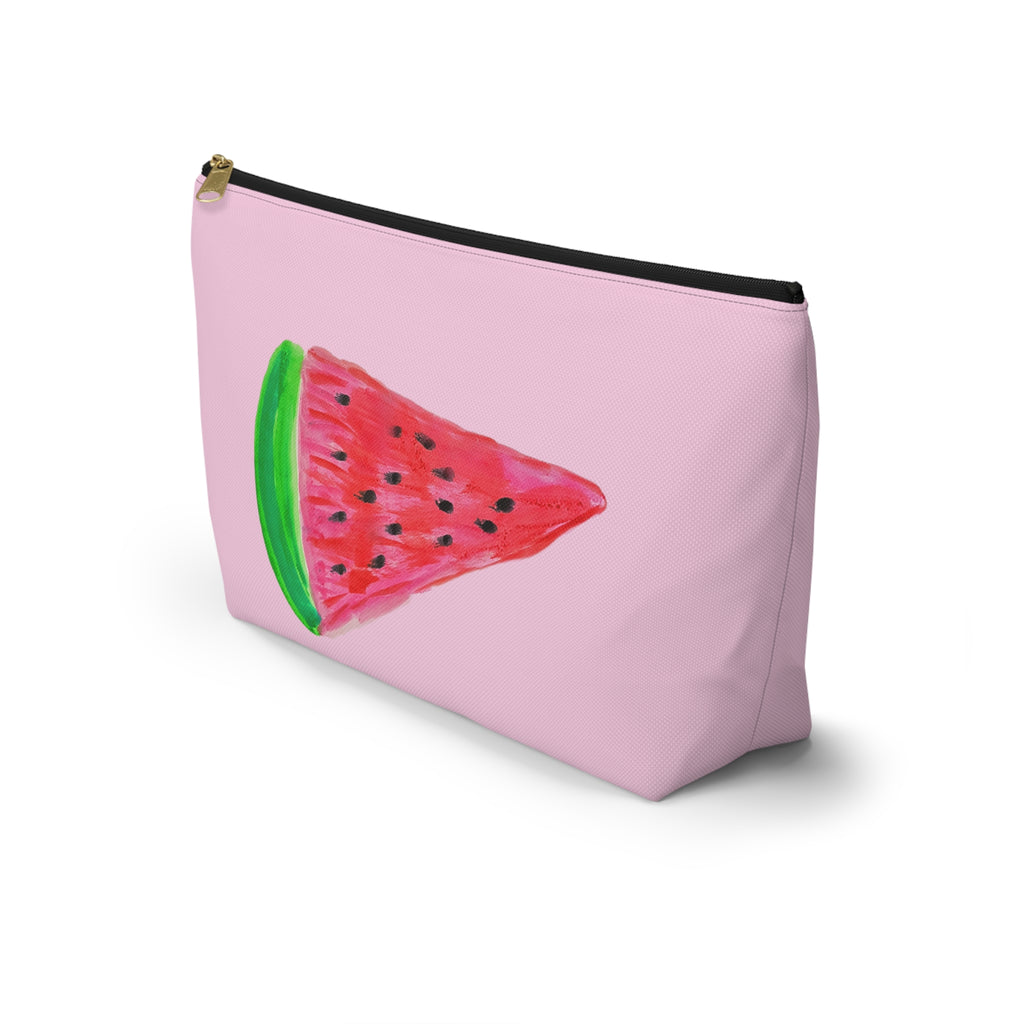 A light pink zippered pouch featuring a printed watermelon slice design on the front, with a black zipper and gold pull, shown on a white background.