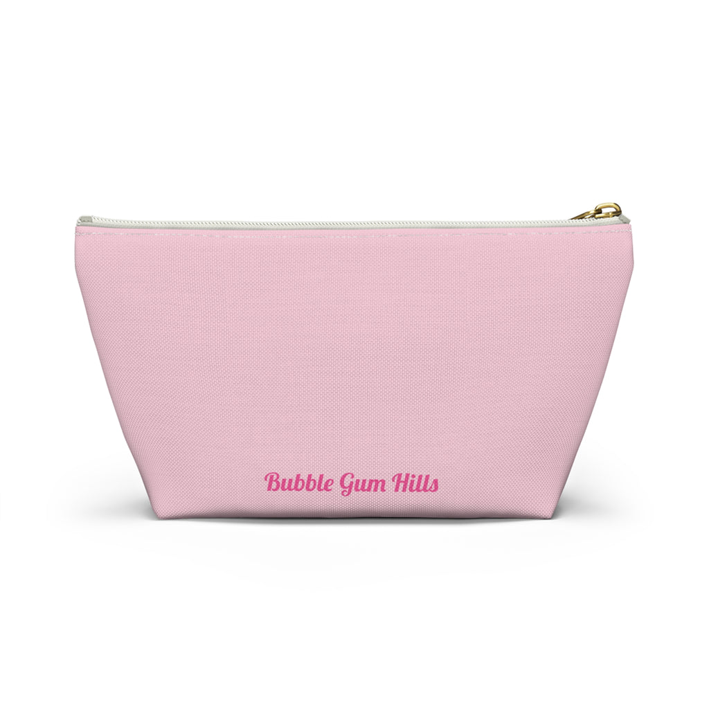 Cute travel makeup bag with a wide T-bottom structure standing upright on a counter