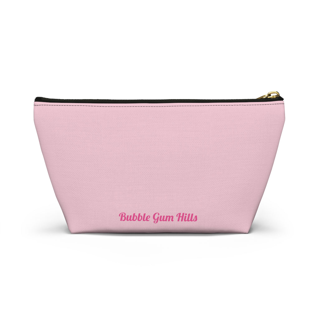 Cute travel makeup bag with a wide T-bottom structure standing upright on a counter