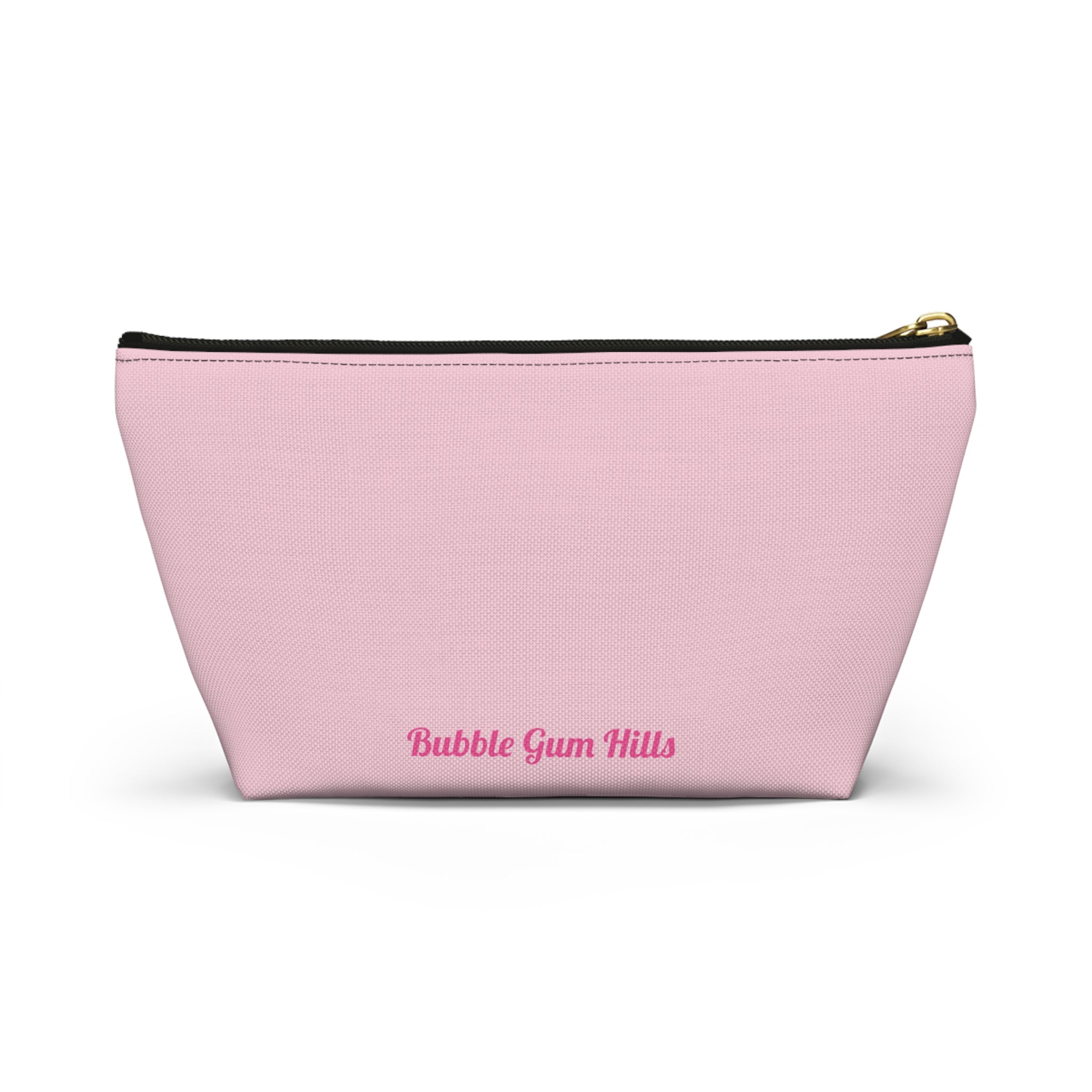 Cute travel makeup bag with a wide T-bottom structure standing upright on a counter