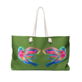 A green tote bag with white rope handles, featuring a colorful watercolor-style print of two hummingbirds on the front. Beautiful birds. 