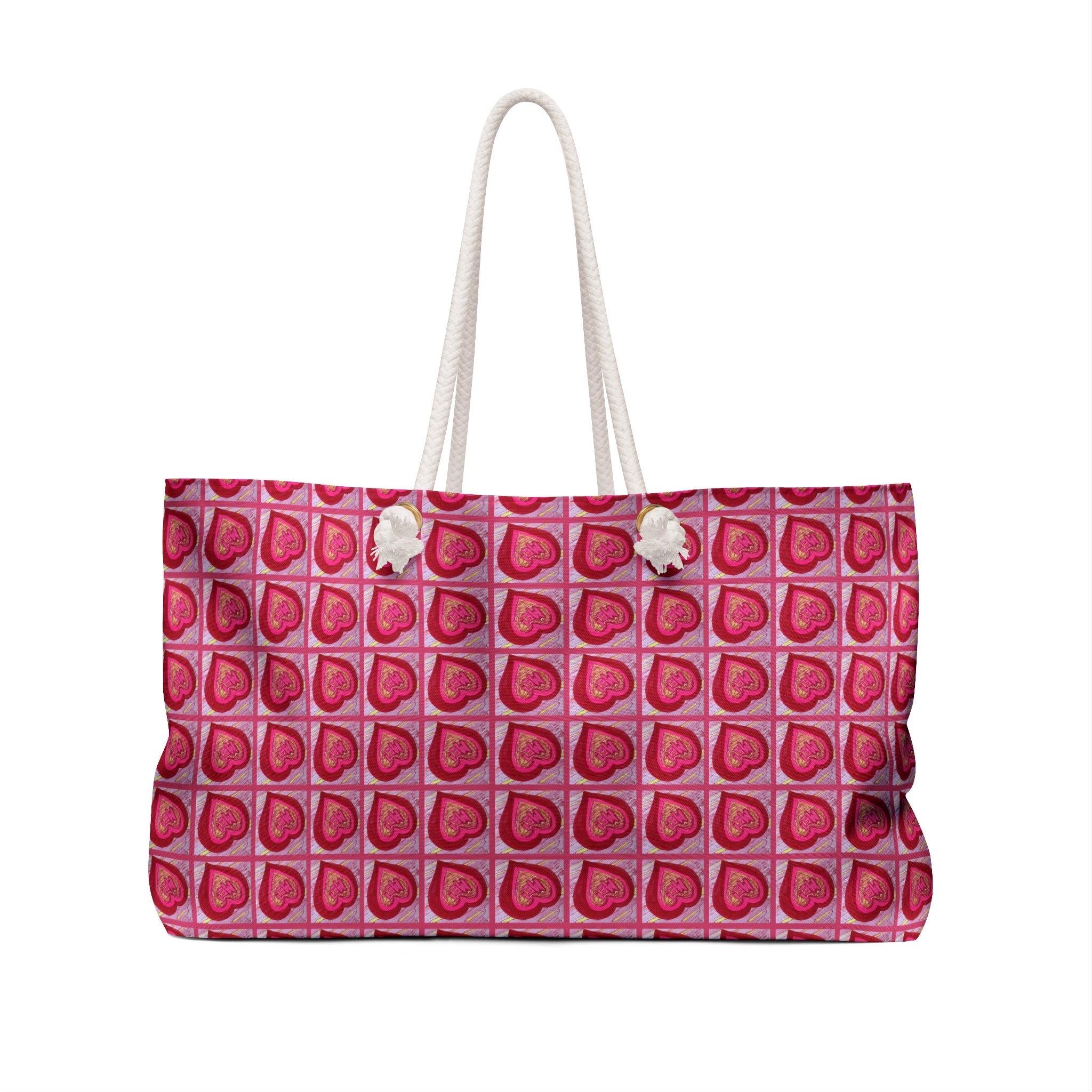 A tote bag with a repeating pattern of pink and red hearts on a light pink background, featuring white rope handles with white pom-pom accents, shown against a plain white background.