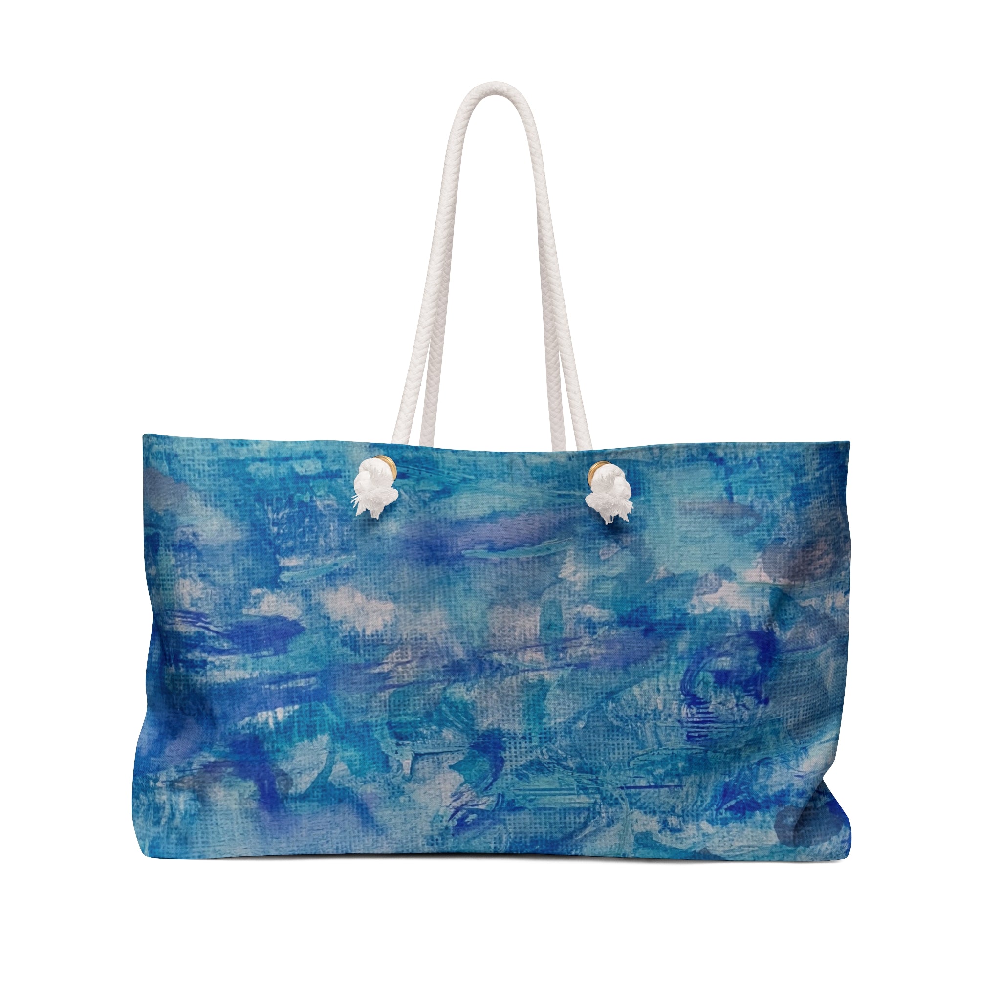 A canvas tote bag featuring an abstract blue and white painted pattern, with two white rope handles, shown against a plain white background.