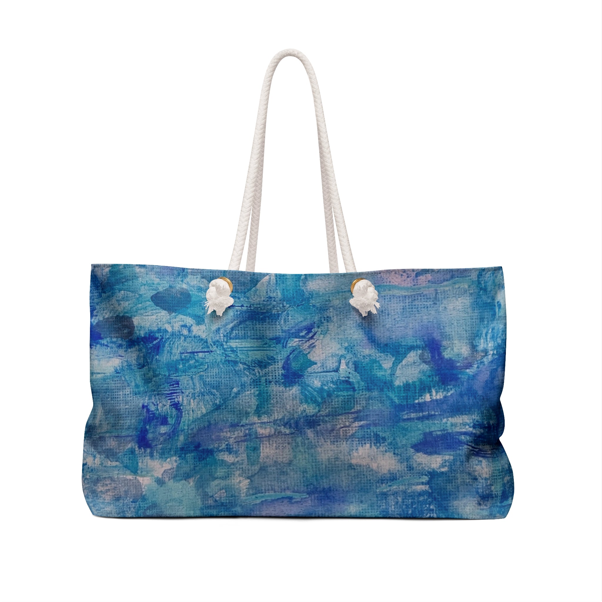 A tote bag featuring an abstract blue and teal painted pattern, complete with two white rope handles and decorative white shell charms on the front.