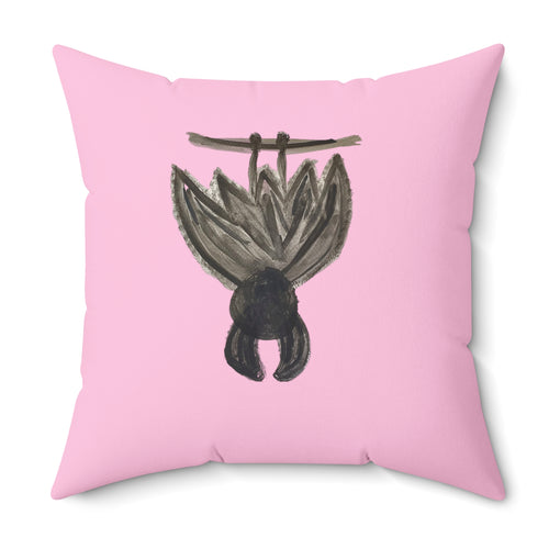 A square pink throw pillow featuring a hand-painted style illustration of a hanging bat in black and gray on the front, set against a plain white background.