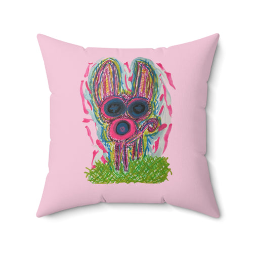 A square pink throw pillow featuring a colorful, hand-drawn style graphic of a rabbit wearing pink sunglasses and standing on green grass, set against a plain white background.
