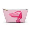Pink accessory cosmetics pouch featuring a playful hand-printed bubble-gum puppy dog motif with a black zipper