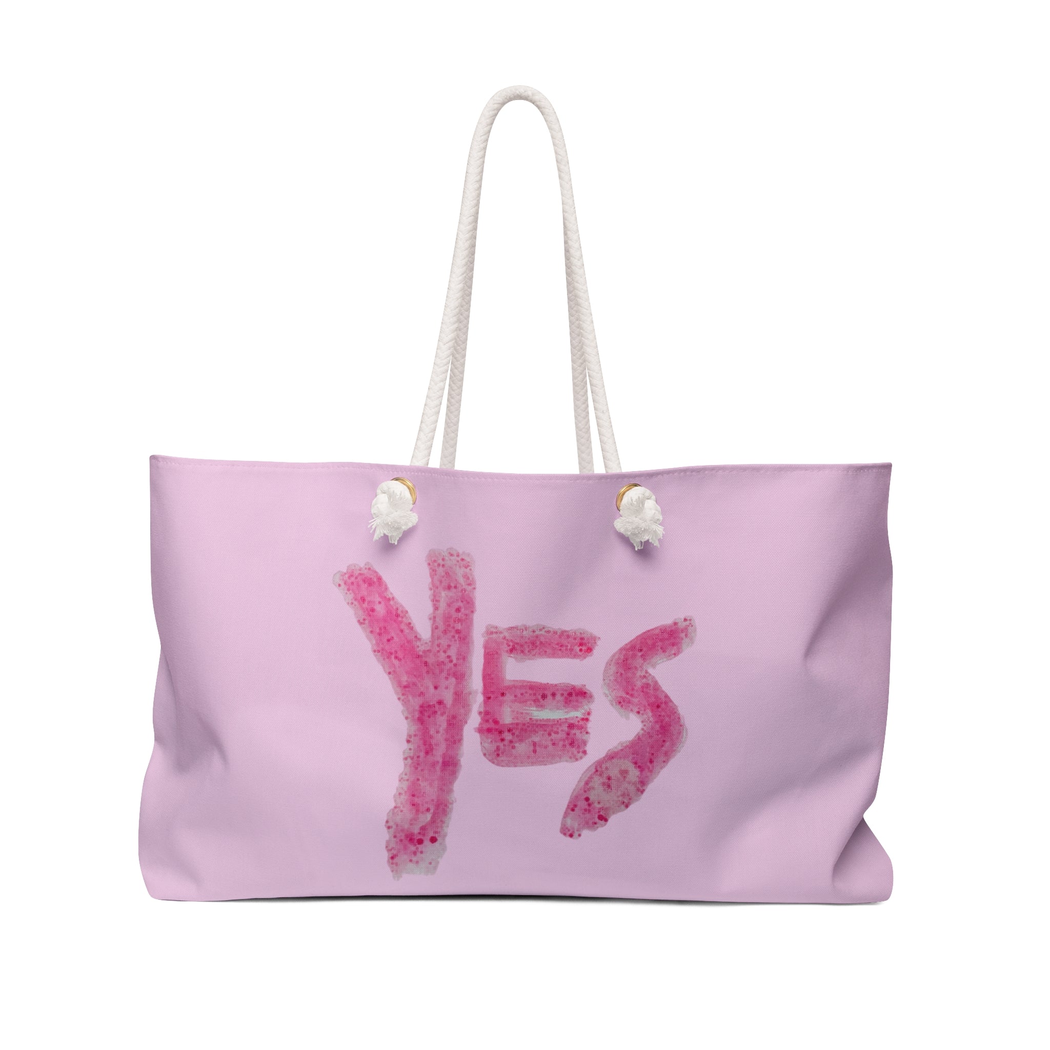 "Large pale pink weekender tote bag featuring a bold rose-toned 'YES' paint motif with thick cream cotton rope handles."