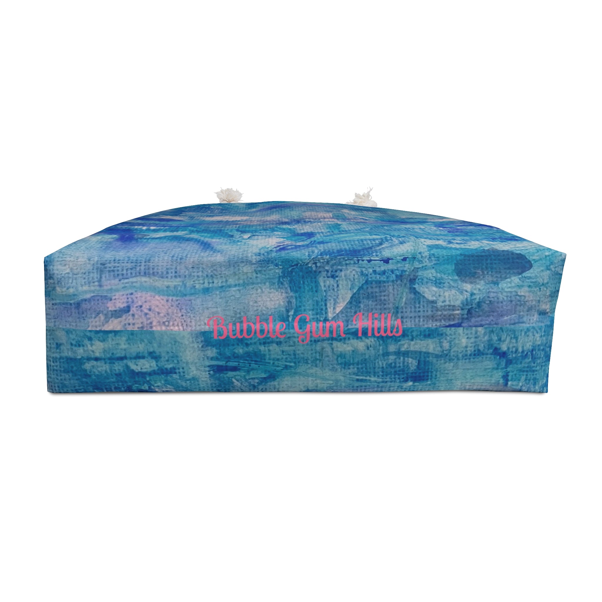 Ocean watercolor bag A rectangular floor cushion with a blue and purple abstract landscape print, featuring the text 'Bubble Gum Hills' in pink script across the center, set against a plain white background.