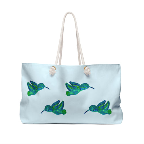 Large sky-blue weekender tote bag featuring a beautiful watercolor pattern of emerald and teal hummingbirds with thick cream rope handles