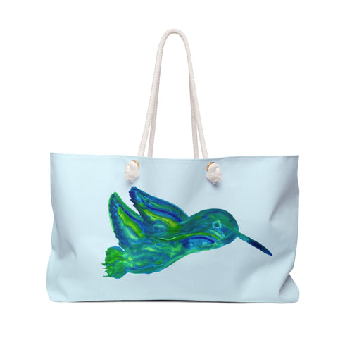 Large sky-blue weekender tote bag featuring a beautiful watercolor pattern of emerald and teal hummingbirds with thick cream rope handles.